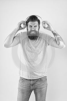 Awful sound. Hipster listen broken headphones music gadget. Hateful song. Music taste. Bearded guy dislike music