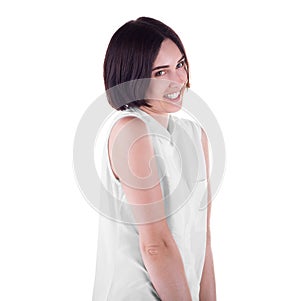 An awkward woman isolated on a white background. An attractive and playful girl. A joyful casual lady wearing a light shirt.