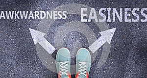 Awkwardness and easiness as different choices in life - pictured as words Awkwardness, easiness on a road to symbolize making