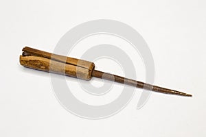 Awl tool made of wood and metal on gray background