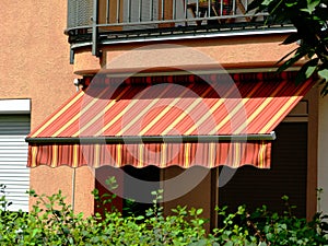 Awning sunshade in yellow and orange color canvas fabric material