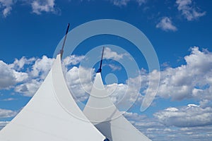 Awnings in sail shape against a blue sky background