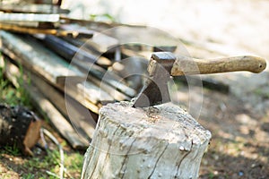 Ax, hatchet, axe. split a log with an ax. birch firewood in the