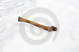 Ax head buried in snow