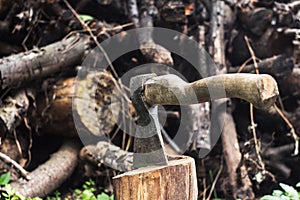 An ax in a hemp on logs background