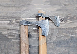 Ax pair of fighting tools on wooden background