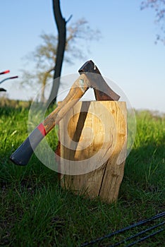 Axe. Big axe in a wood log. Chopping the wood.