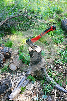 Axe cutting fire wood on stub