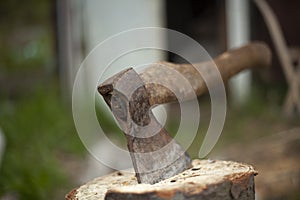 Axe in log. Axe for chopping firewood. Garden tool