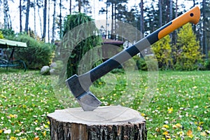 Axe in stump. Axe ready for cutting timber.Woodworking tool. Lumberjack axe in wood chopping timber. Travel adventure camping gear