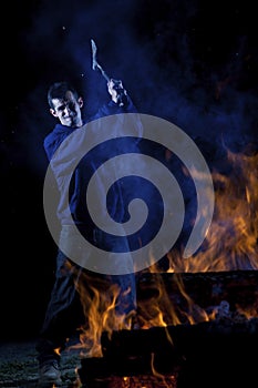 Axe wielding maniac by a fire