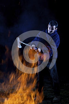 Axe wielding maniac by a fire photo