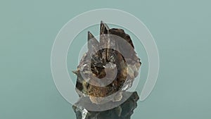 Axinite Crystals Specimen seamlessly rotating on glass surface