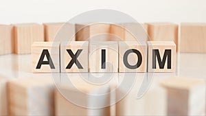 axiom - word on wooden cubes on white background, concept