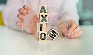 Axiom - word on wooden cubes on white background, concept