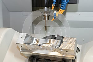 The 5-axis CNC milling machine  cutting the mold and die parts by solid ball endmill tools. photo