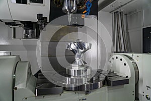 The 5-axis CNC milling machine  cutting the sample of aluminium  parts by solid ball endmill tools. photo