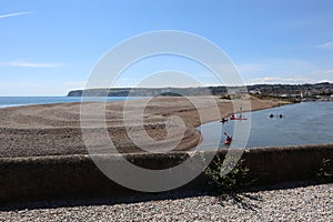 AXMOUTH, DEVON,ENGLAND - JULY 12TH 2020: Canoes make their way along the river Axe towards the marina at Axmouth