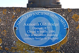 AXMOUTH, DEVON,ENGLAND - JULY 12TH 2020: The plaque on the old bridge over the river Axe at Axmouth