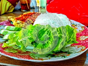 Ayam geprek is a typical Indonesian flour fried chicken food that is pulverized or crushed with chili sauce.