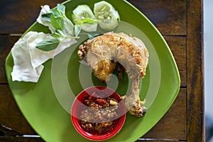 Ayam Penyet (smashed fried chicken), a common Javanese food found at street of Indonesia.