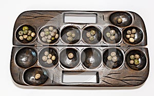 Ayo Olopon. Some call it Mancala. A Yoruba Nigerian brain game.