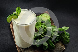 Ayran or Doogh is a popular refreshing yogurt on a dark background. Restaurant menu, dieting, cookbook recipe top view