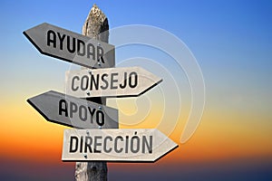 Ayudar, consejo, apoyo, direccion - Spanish/ help, advice, support, direction - English - wooden signpost, sunset sky