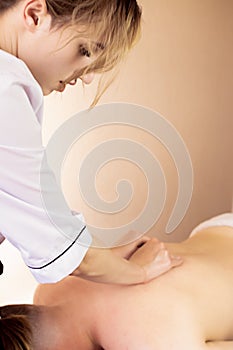 Ayurveda beck and shoulder blade massage with ayurvedic oil, girl massaging a girl, Concept of relaxation and body care. Close up