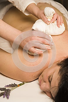 Ayurveda massage with herbs in the spa