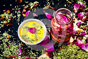 Ayurvedic face pack of dried grounded leaves of Indian iliac or neem with gram flour and rose water with some rose petals on woode