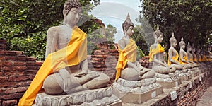 Ayutthaya, Thailand - June 29, 2019: a row of Buddhas at Buddhist temple Wat Yai Chai Mongkhon