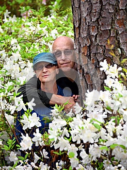 Azaleas Surround Hugging Couple