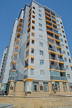 Facade of modern multi-storey new residential orange building near BAku . New apartment house . Storey houses modern