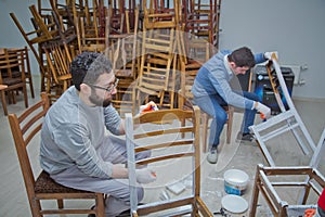 Two people. Old chairs are painted white . Azerbaijan Baku . 17.05.2020