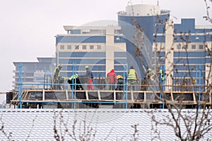 Workers place rails on the building . Authentic construction worker busy on the positioning of formwork frames in