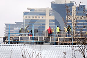 Workers place rails on the building . Authentic construction worker busy on the positioning of formwork frames in