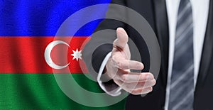 Azerbaijan concept. Business shaking hand to agree to joint business agreements on Azeri flag background