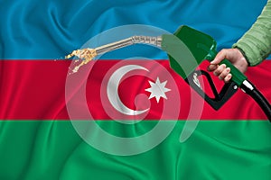 AZERBAIJAN flag Close-up shot on waving background texture with Fuel pump nozzle in hand. The concept of design solutions. 3d