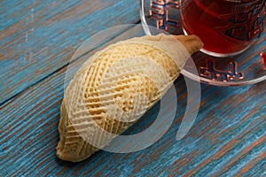 Azerbaijan pastry shekerbura with and glass of black tea