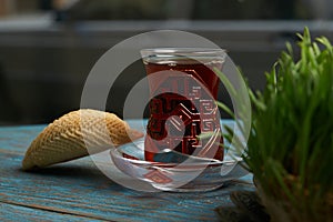 Azerbaijan pastry shekerbura with and glass of black tea