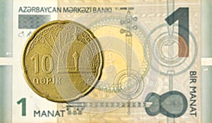 10 azerbaijani qepik coin against 1 azerbaijani manat bank note