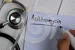 Azithromycin text write on a book isolated on office desk. Healthcare/Medical concept