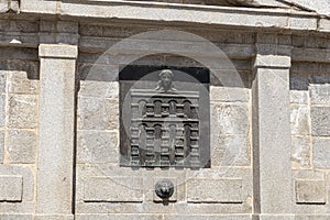 Azoguejo Fountain in the Plaza del Azoguejo, with the emblem of Segovia. Segovia, Spain. photo