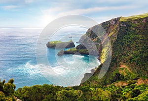 Azores - Flrores island - View from Miradouro do Ilheu Furado towards the Atlantic ocean and the sea cliffs with sun and blue sky