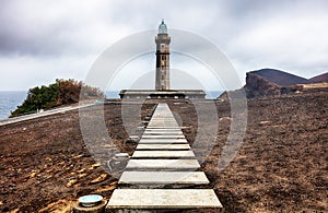 Azores, Island of Faial. The lighthouse Farol dos Capelinhos at Ponta dos Capelinos photo