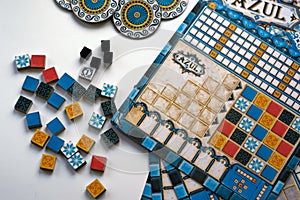 Azul components of board game on white background. Gameful plates and fields during gameplay. Leisure, family and friends time