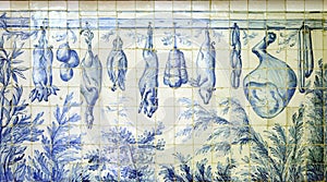Azulejos representing food in old portuguese butcher's shop photo