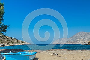 Azure fishermans boat and sea horizon line on Alexi or Alexis beach near Emborios Greek village on Kalymnos island