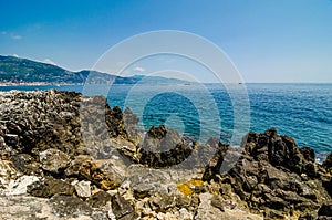 Azure Meidterranean Sea and stony cliff in Roquebrune Cap Martin in France